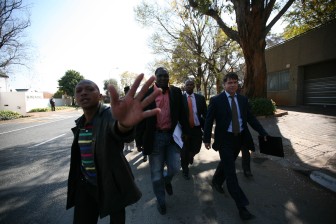 South African journalist Mzilikazi wa Afrika (second from left) being arrested in Johannesburg